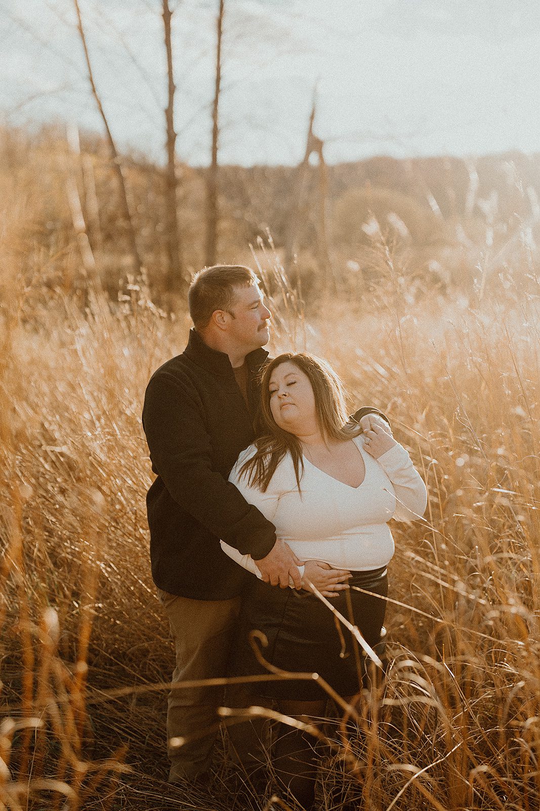 Couple embracing by Lake Ontario at Sterling Nature Center during golden hour in autumn