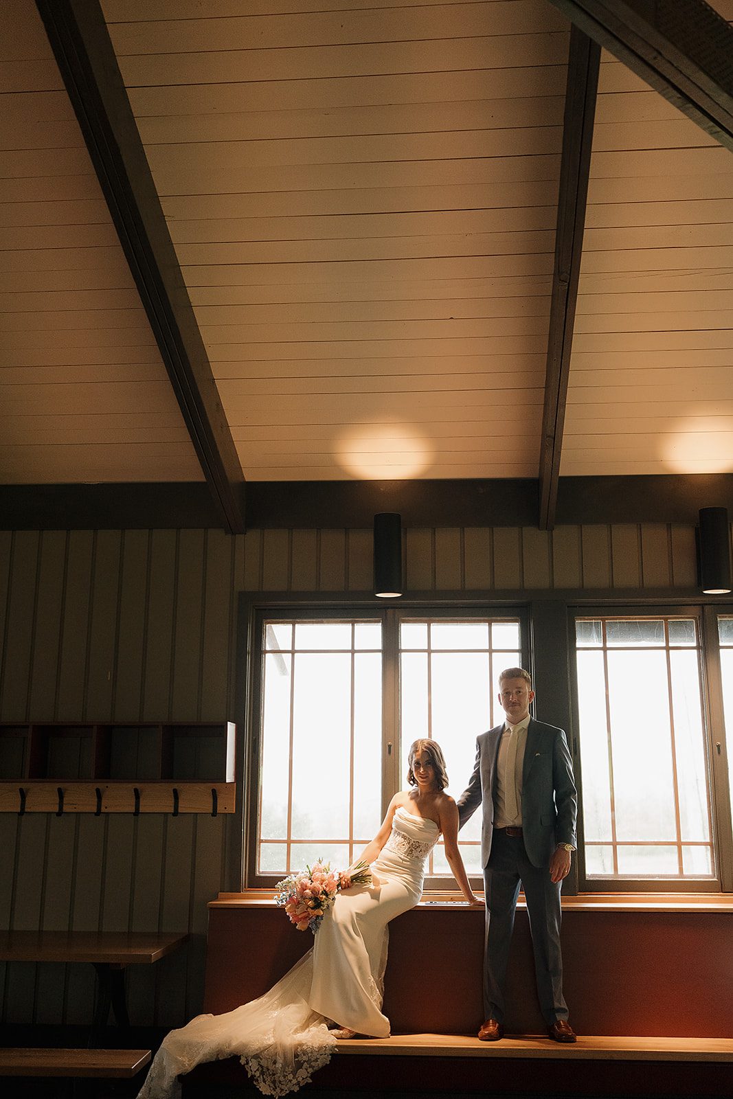 Michelle and Thomas embracing during their rainy wedding day at Song Mountain in Tully, New York